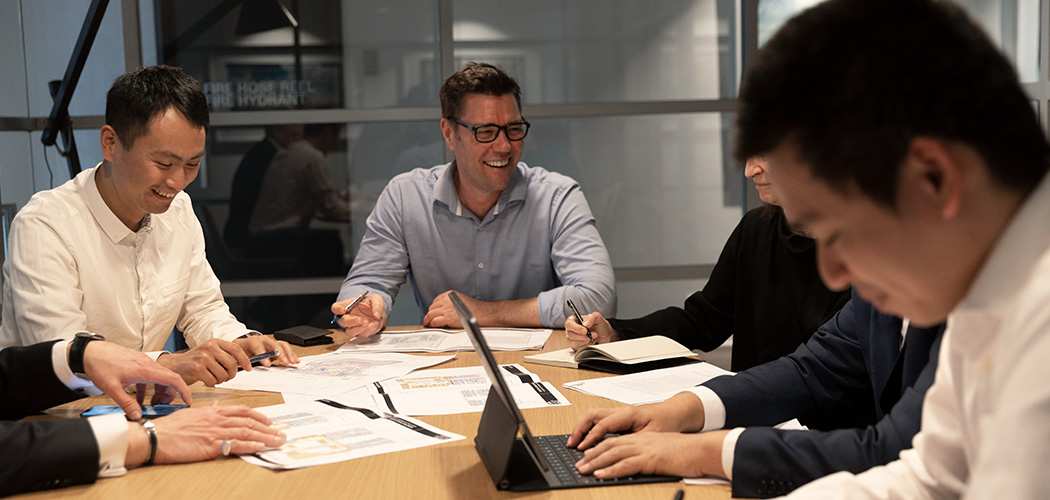 One Fell Swoop - people in a meeting around a boardroom table