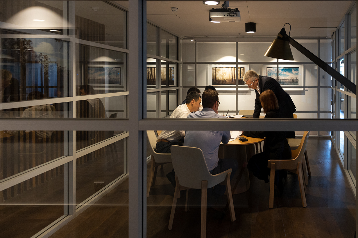 One Fell Swoop - people in a meeting around a boardroom table