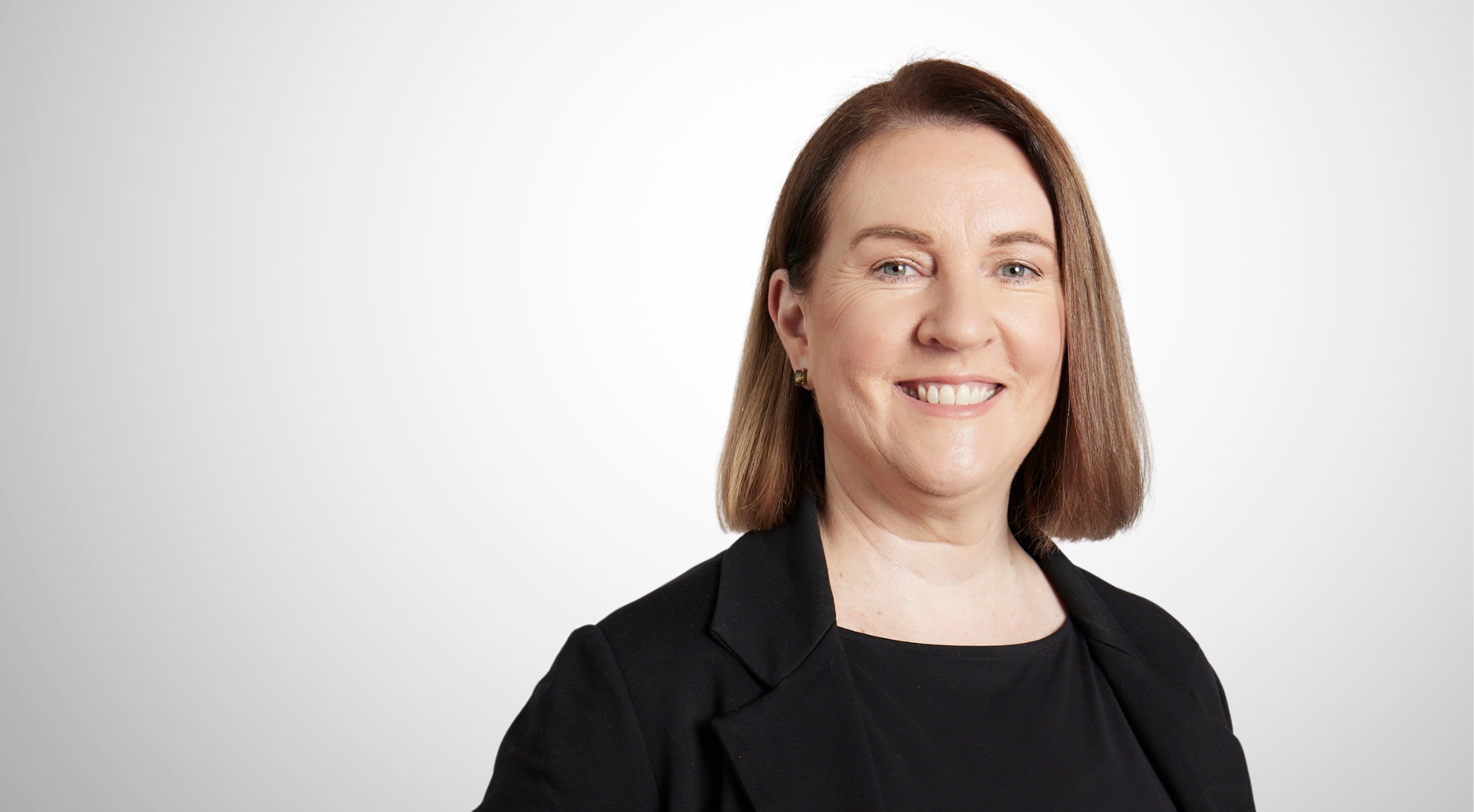 Headshot of female senior living operations manager with light brown bobbed hair smiling at the camera. 